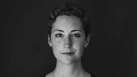 grayscale photo of woman wearing necklace and top