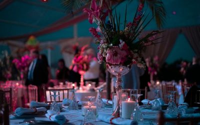 a table with a vase of flowers and candles on it