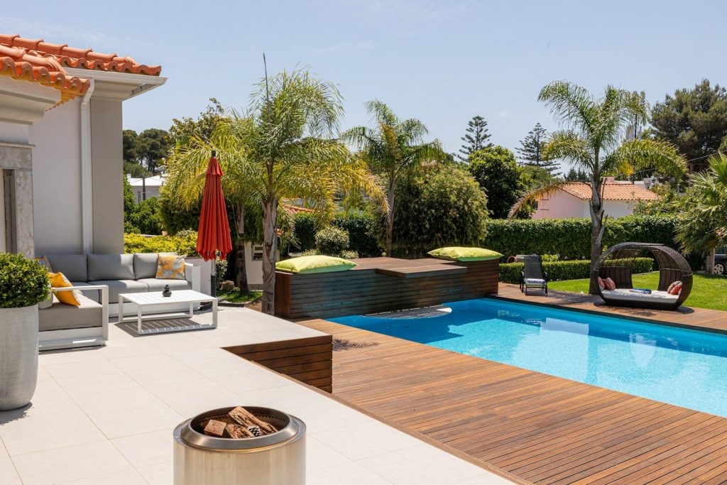 Beautiful backyard with a pool and lounge area.